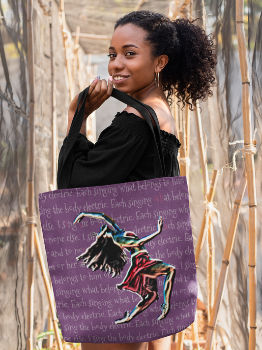 Image of woman with dark curly hair carrying Body Electric tote bag by Habadassery.