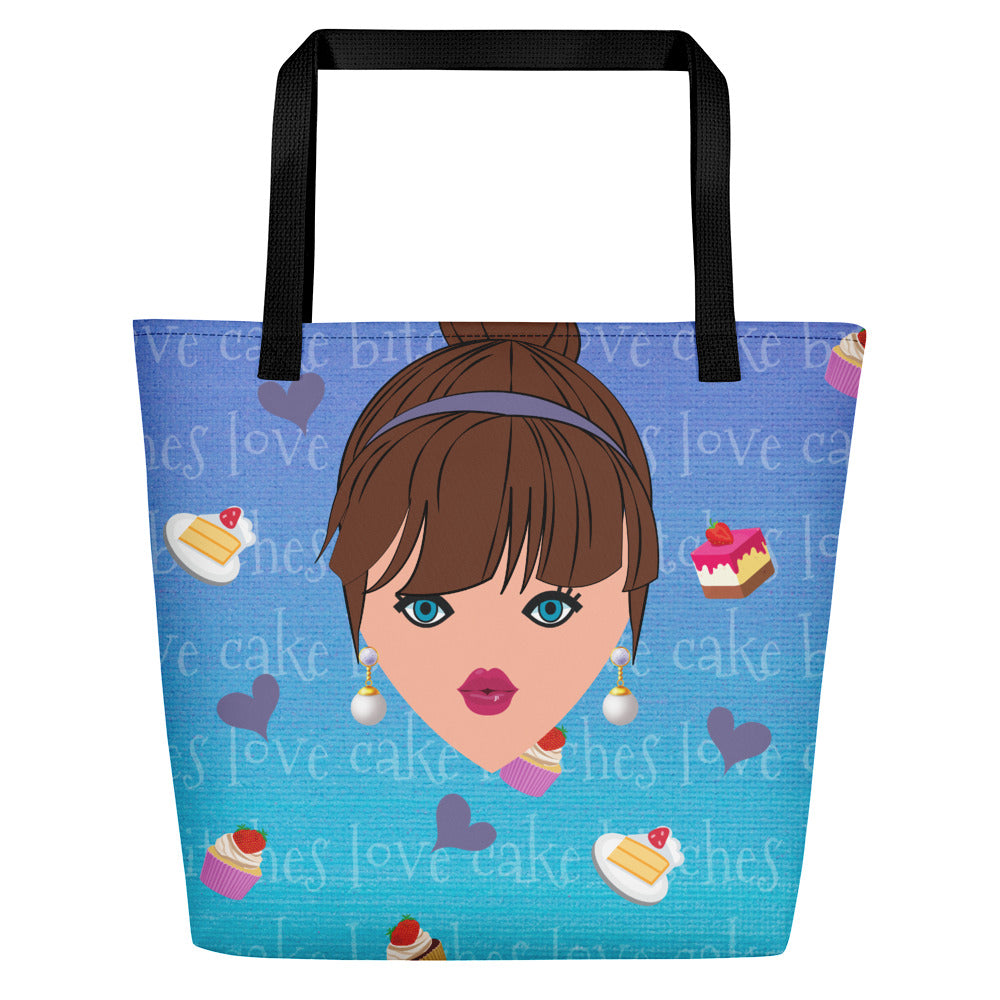 Image of blue tote bag with black cotton web handles. Tote bag has cartoon image of woman with pearl drop earrings on a blue background with images of cake, hearts, and text that reads bitches love cake.